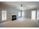 Bright and airy living room with a fireplace, neutral paint, and access to the backyard at 1074 Frog Leap Nw Trl, Kennesaw, GA 30152
