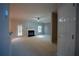 Cozy living room with fireplace, natural light, and door to the backyard at 1074 Frog Leap Nw Trl, Kennesaw, GA 30152