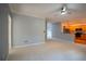 Open-concept living room flows into a kitchen with stainless steel appliances and a breakfast bar at 1074 Frog Leap Nw Trl, Kennesaw, GA 30152