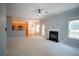 Open-concept living area with fireplace leading to the modern kitchen, ideal for Gathering gatherings at 1074 Frog Leap Nw Trl, Kennesaw, GA 30152