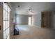 Spacious living room featuring neutral paint, carpet, fireplace, and ample natural light from the French doors at 1074 Frog Leap Nw Trl, Kennesaw, GA 30152