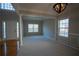 Bright and spacious living room with a neutral color palette, hardwood floors, elegant moldings, and plenty of natural light at 1074 Frog Leap Nw Trl, Kennesaw, GA 30152