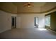 Spacious carpeted main bedroom featuring a tray ceiling, and doorway access to the bathroom at 1074 Frog Leap Nw Trl, Kennesaw, GA 30152