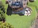 Aerial view of the backyard featuring a deck, patio, hot tub, fire pit, and lush landscaping at 5124 Parkwood Oaks Ln, Smyrna, GA 30126