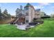 A two-story home's back exterior features a deck, fireplace, hot tub, and patio with mature landscaping at 5124 Parkwood Oaks Ln, Smyrna, GA 30126