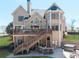 Stunning back exterior view of a two-story home with a deck, patio, and manicured lawn at 5124 Parkwood Oaks Ln, Smyrna, GA 30126