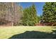 Expansive backyard with lush green grass and mature trees, perfect for outdoor activities at 5124 Parkwood Oaks Ln, Smyrna, GA 30126