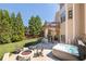 Beautiful backyard with a stone patio, fire pit, hot tub, and outdoor kitchen area at 5124 Parkwood Oaks Ln, Smyrna, GA 30126