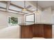 Basement area with a bar, projector screen, coffered ceilings, and access to the outdoors at 5124 Parkwood Oaks Ln, Smyrna, GA 30126