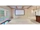 Finished basement area with projector screen and access to outside at 5124 Parkwood Oaks Ln, Smyrna, GA 30126