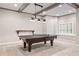 Finished basement with a game table area under decorative lighting near a window at 5124 Parkwood Oaks Ln, Smyrna, GA 30126