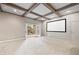 A finished basement featuring coffered ceilings, a projector screen, and access to the outdoors at 5124 Parkwood Oaks Ln, Smyrna, GA 30126
