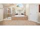 Bathroom showcasing a soaking tub, glass-enclosed shower, and a neutral color scheme at 5124 Parkwood Oaks Ln, Smyrna, GA 30126