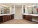 Bathroom featuring dual vanities, decorative columns, and a view to the walk-in closet and shower at 5124 Parkwood Oaks Ln, Smyrna, GA 30126