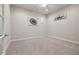 Minimalist bedroom featuring neutral walls, carpet, ceiling fan, and modern artwork at 5124 Parkwood Oaks Ln, Smyrna, GA 30126
