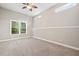 Cozy bedroom with plush carpet, a ceiling fan, and a window providing natural light at 5124 Parkwood Oaks Ln, Smyrna, GA 30126