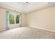 Neutral bedroom with a window and tan carpet at 5124 Parkwood Oaks Ln, Smyrna, GA 30126