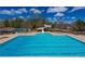 Community pool featuring a waterslide, seating, and mature landscaping at 5124 Parkwood Oaks Ln, Smyrna, GA 30126