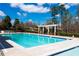 Community pool with lounge chairs and pergola in the background, surrounded by lush greenery at 5124 Parkwood Oaks Ln, Smyrna, GA 30126