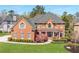 Manicured lawn leads up to this charming two-story brick home with a covered front entrance at 5124 Parkwood Oaks Ln, Smyrna, GA 30126