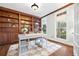 Home office with built-in bookshelves, hardwood floors, and natural light at 5124 Parkwood Oaks Ln, Smyrna, GA 30126