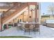 Covered outdoor bar with stone counter, seating, and a view of the lush backyard and hot tub at 5124 Parkwood Oaks Ln, Smyrna, GA 30126