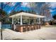 Outdoor kitchen and bar area with seating, perfect for entertaining near the tennis courts at 5124 Parkwood Oaks Ln, Smyrna, GA 30126