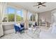 Bright sunroom featuring large windows, a ceiling fan, comfortable seating and pleasant natural light at 5124 Parkwood Oaks Ln, Smyrna, GA 30126