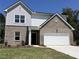 Charming two-story brick home featuring a white garage door, well-manicured lawn, and a classic architectural design at 196 Silverton Dr, Dacula, GA 30019
