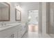 Modern bathroom with double sinks, white marble shower, and view into the bedroom at 2340 Edgar Park Pl # 97, Duluth, GA 30096