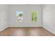 Bright bedroom with hardwood floors and two windows with neighborhood views at 2340 Edgar Park Pl # 97, Duluth, GA 30096