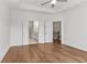 Spacious bedroom with hardwood floors and white doors leading to a bathroom and staircase at 2340 Edgar Park Pl # 97, Duluth, GA 30096