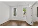 Bright bedroom with hardwood floors, two windows, and a door to the outside at 2340 Edgar Park Pl # 97, Duluth, GA 30096