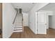 Bright entryway with hardwood floors and white staircase leading to the upper level at 2340 Edgar Park Pl # 97, Duluth, GA 30096