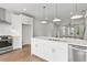 Open-concept kitchen with stainless appliances, white cabinets and a large island perfect for entertaining at 2340 Edgar Park Pl # 97, Duluth, GA 30096