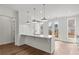 A kitchen with white cabinets, hardwood floors, island with sink, and stainless appliances at 2340 Edgar Park Pl # 97, Duluth, GA 30096