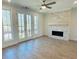 Living room featuring a modern fireplace, large windows, and access to the balcony at 2340 Edgar Park Pl # 97, Duluth, GA 30096