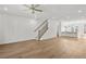 Open-concept living area showcasing hardwood floors, staircase, and modern kitchen at 2340 Edgar Park Pl # 97, Duluth, GA 30096