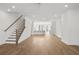 Open living space featuring hardwood floors, staircase, and a bright modern kitchen at 2340 Edgar Park Pl # 97, Duluth, GA 30096