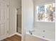 Bathroom featuring a door, stand up shower, large window and a bathtub at 4785 Beaver Rd, Loganville, GA 30052