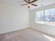 Bedroom with plush carpet, a ceiling fan, and a view from the window at 4785 Beaver Rd, Loganville, GA 30052
