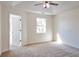 Bedroom with plush carpet, a ceiling fan, and a view from the window at 4785 Beaver Rd, Loganville, GA 30052