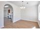 Bright dining room with new floors, chandelier, and archway to the kitchen at 4785 Beaver Rd, Loganville, GA 30052