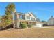 Inviting two-story home with a charming front porch, attached garage, and landscaped yard at 4785 Beaver Rd, Loganville, GA 30052