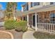 Close up of stone-accented front porch, white railing, well manicured bushes and address number at 4785 Beaver Rd, Loganville, GA 30052