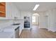 Updated kitchen with stainless appliances, light wood floors, and white cabinets at 4785 Beaver Rd, Loganville, GA 30052