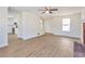 Open-concept living room with new floors, featuring a fireplace and seamless flow to the kitchen at 4785 Beaver Rd, Loganville, GA 30052