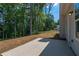 View of a concrete patio that overlooks a wooded backyard with trees at 490 Benson Meadows Dr, Dallas, GA 30157