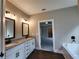 Bathroom with double sinks, granite countertops, and dark fixtures at 490 Benson Meadows Dr, Dallas, GA 30157