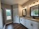 Bright bathroom featuring double sinks with granite countertop and sleek, black hardware at 490 Benson Meadows Dr, Dallas, GA 30157